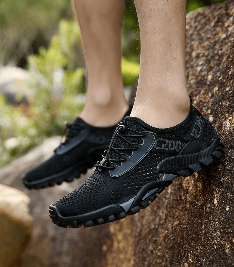 Black breathable elastic camping shoes with lace-up design, ideal for men's outdoor activities and sports.
